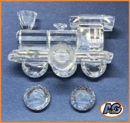 Swarovski crystal locomotive has two detached wheel and can be restored as good as new - if you have hand-eye coordination and steady hands.